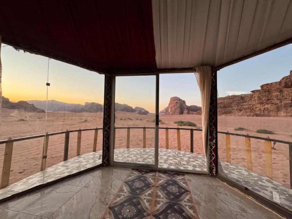a room with a view of the desert from a window at joy of life in Wadi Rum