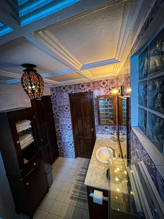 a bathroom with a sink and a ceiling at ORHO HOTEL BOUTIQUE PANAMA Tocumen Airport free shuttle highway round trip 15 minuts in Tocumen
