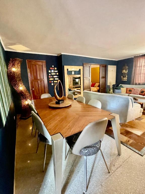 a dining room with a table and chairs and a bedroom at ORHO HOTEL BOUTIQUE PANAMA Tocumen Airport free shuttle highway round trip 15 minuts in Tocumen