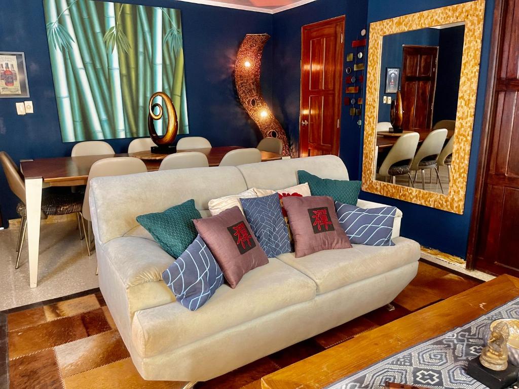 a living room with a couch with pillows on it at ORHO HOTEL BOUTIQUE PANAMA Tocumen Airport free shuttle highway round trip 15 minuts in Tocumen