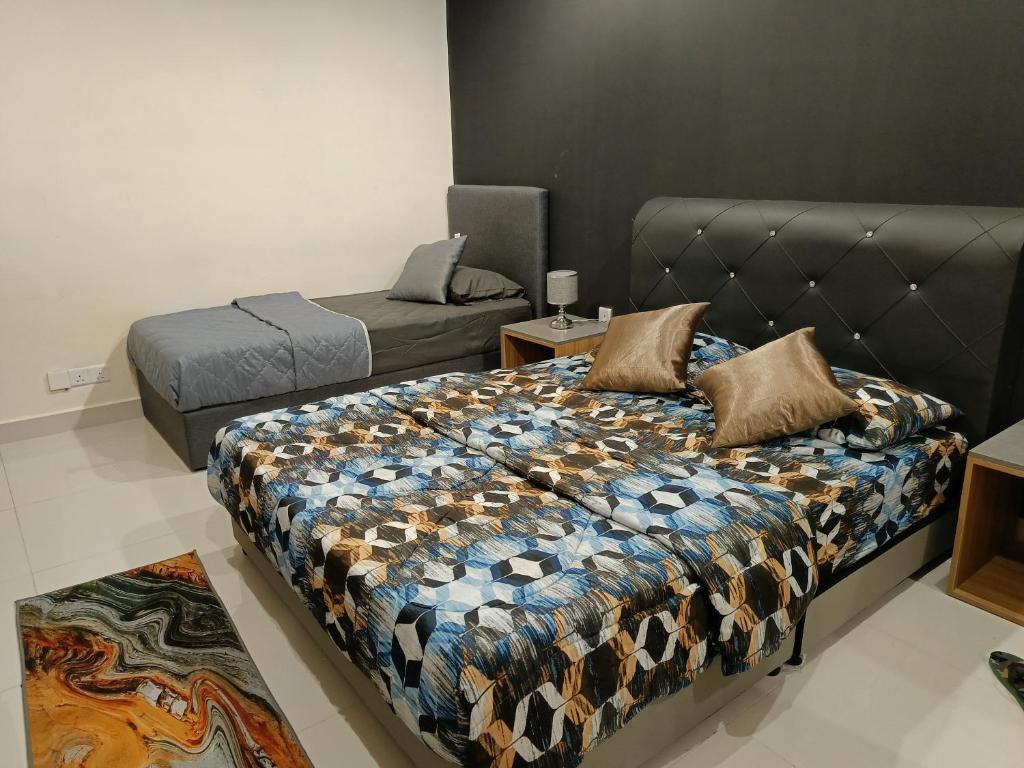 a bedroom with a bed and a couch and a bed at kozi mama paradise in Kuching