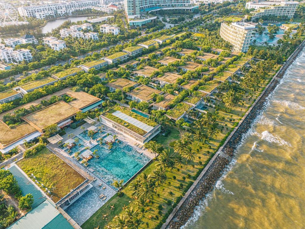 - une vue aérienne sur un complexe avec une piscine et des palmiers dans l'établissement The Victoria Resort Sam Son, à Sầm Sơn