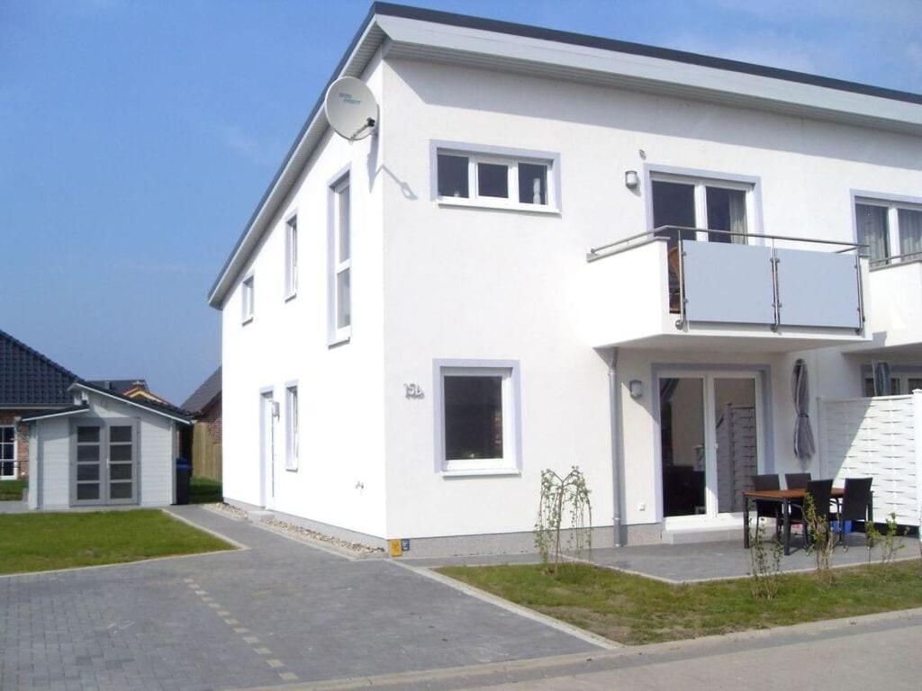 a white house with a lot of windows at Tacke 2 Comfortable holiday residence in Burg auf Fehmarn