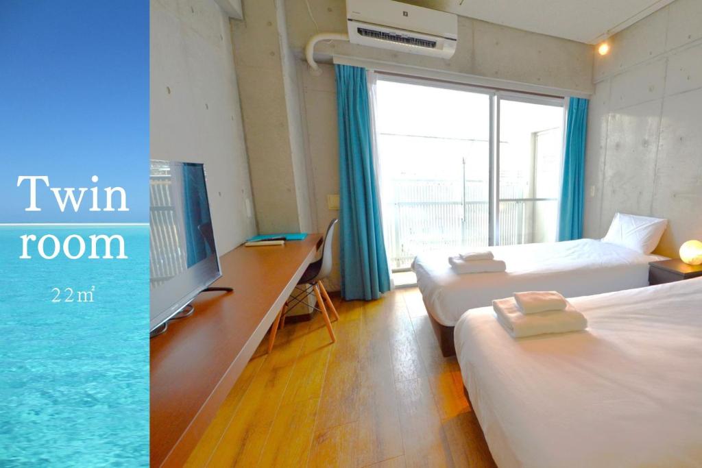 a room with two beds and a tv and a window at Hotel Pescatore Okinawa in Naha