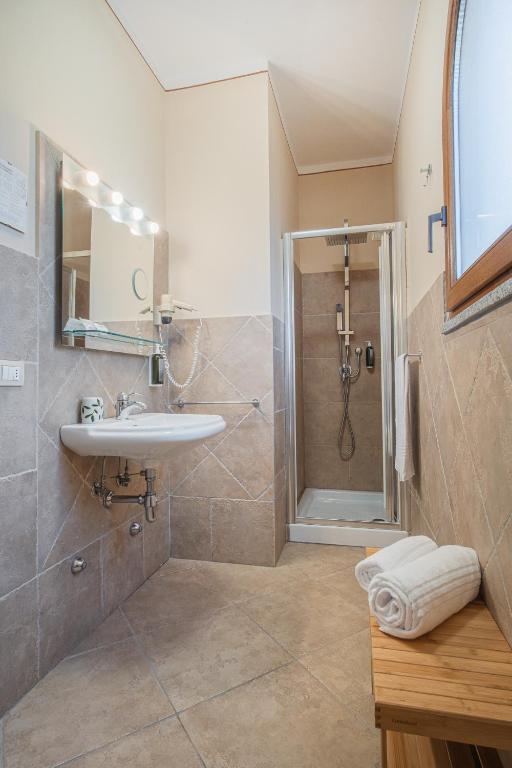 a bathroom with a sink and a shower at Hotel Lu Pitrali in San Teodoro