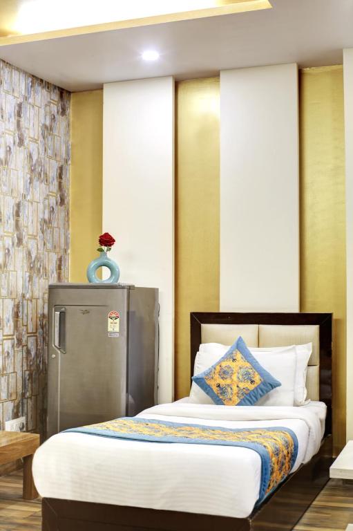 Postel nebo postele na pokoji v ubytování Hotel Grand Manor