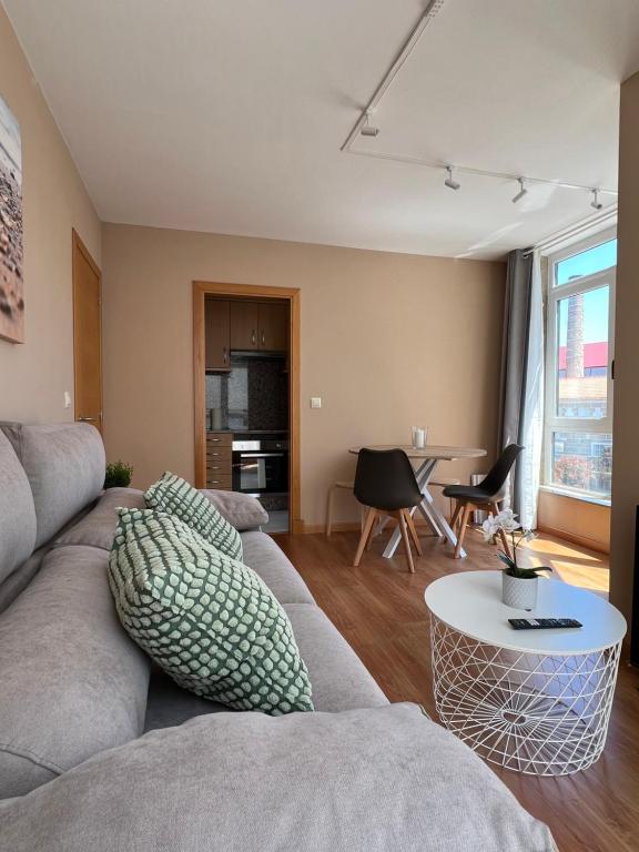 a living room with a couch and a table at Apartamento Pedra Pateira in Ribeira