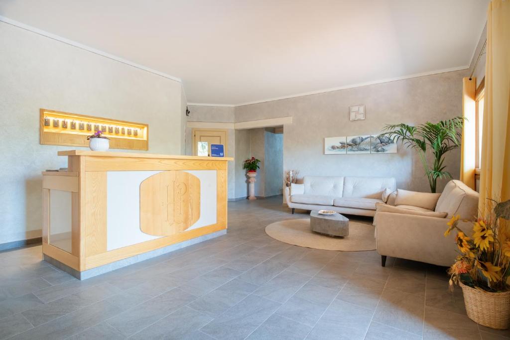 a living room with a couch and a table at Hotel Lu Pitrali in San Teodoro