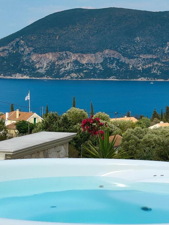 a pool with a view of the water and mountains at Villa Sasà in Fiskardo