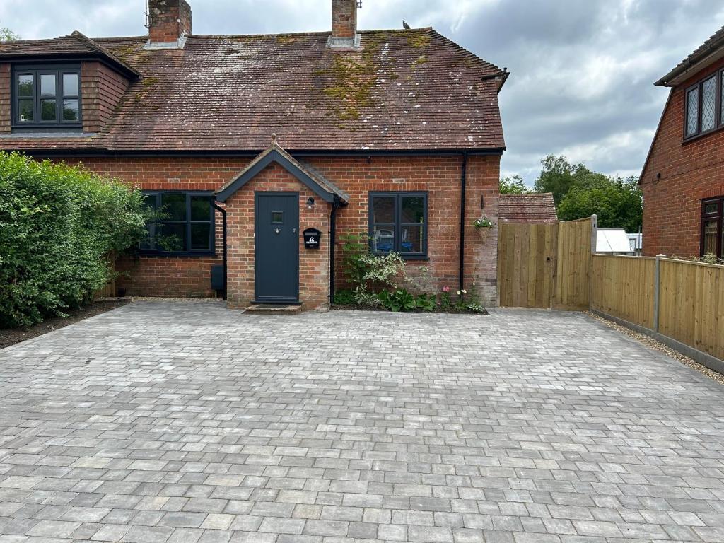 a brick house with a driveway in front of it at Bee Cottage - Romsey in Romsey