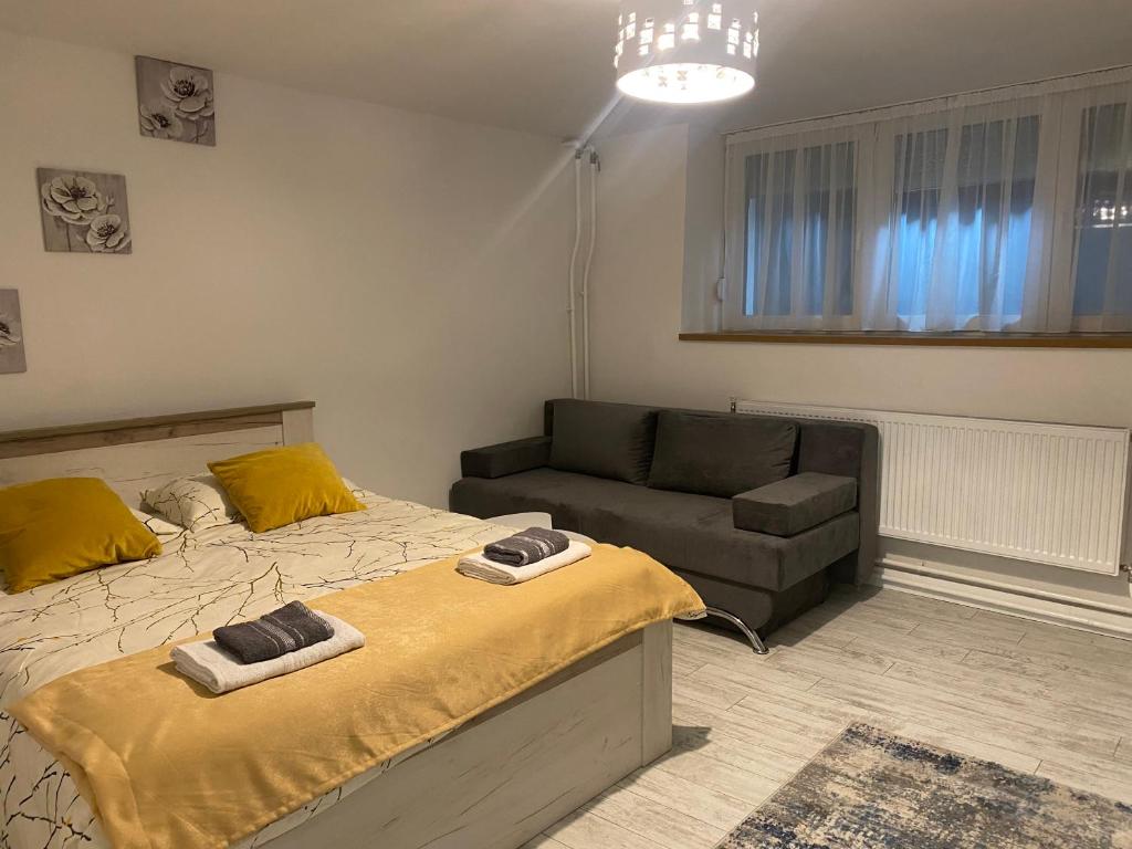 a bedroom with a bed and a couch at Elite Luxury 2 BR Apartment in the heart of Historical Sarajevo Old Town in Sarajevo