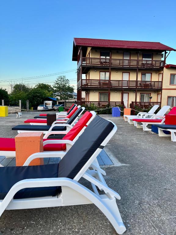 a row of lounge chairs in front of a building at Casa Luca 2 in Vama Veche