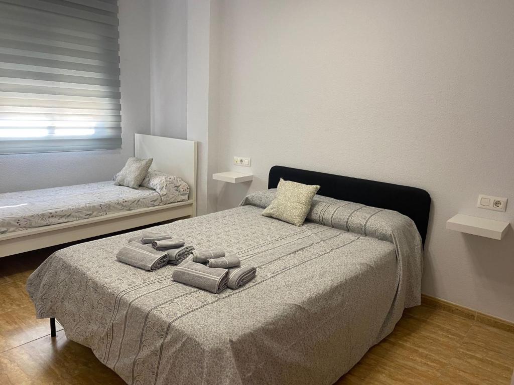 a bedroom with a bed with two pillows on it at BALERMAPLAYA calle lago in Belerma