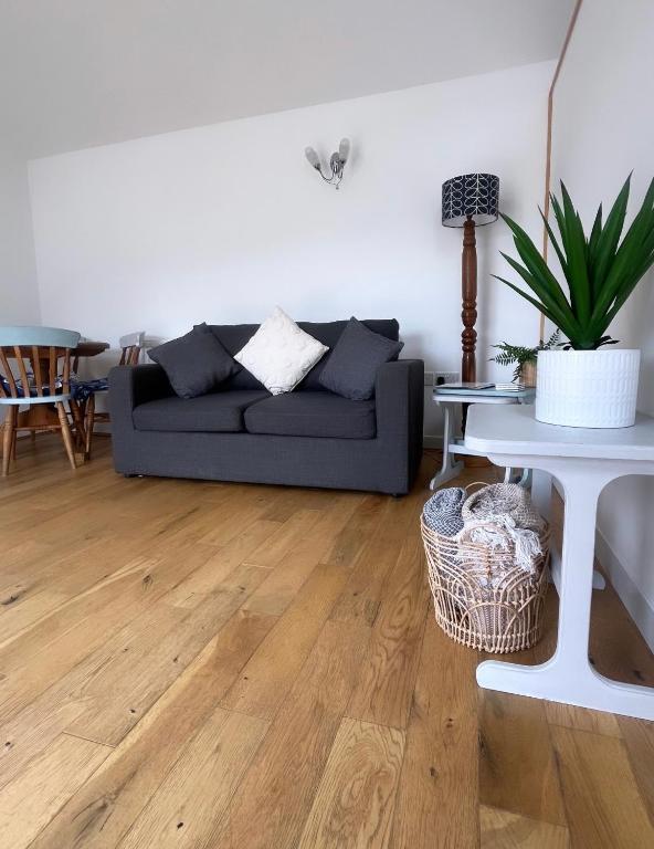 a living room with a couch and a table at The Annex - Penzance town centre with parking in Penzance