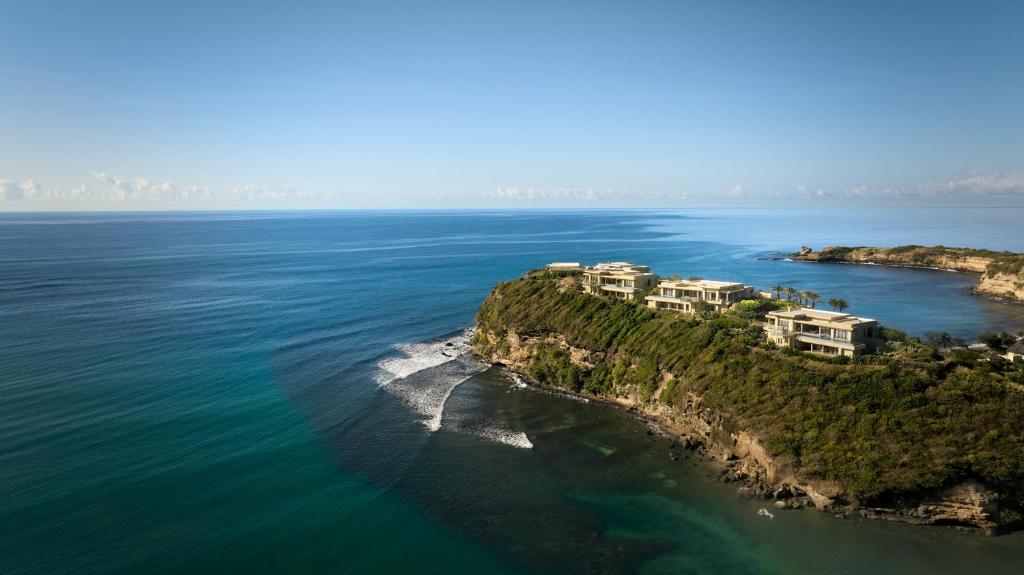 an aerial view of an island in the ocean at Six Senses La Sagesse 