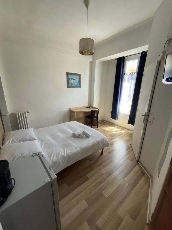 Postel nebo postele na pokoji v ubytování Hôtel Trianon