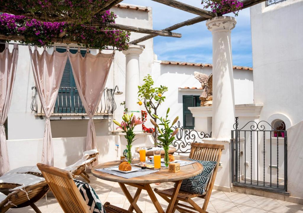 a patio with a table and chairs on a balcony at alle Stelle b&b in Anacapri