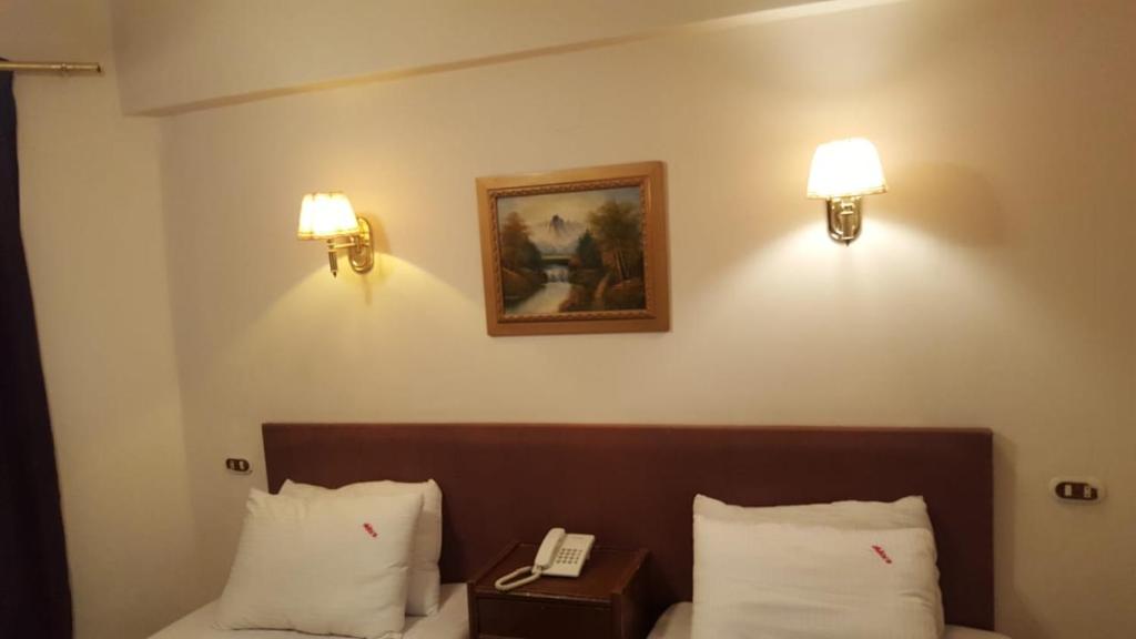 Postel nebo postele na pokoji v ubytování Sandy Hotel