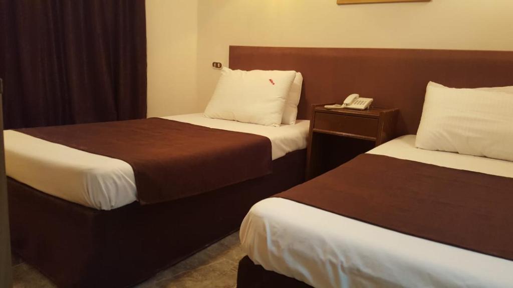 Postel nebo postele na pokoji v ubytování Sandy Hotel
