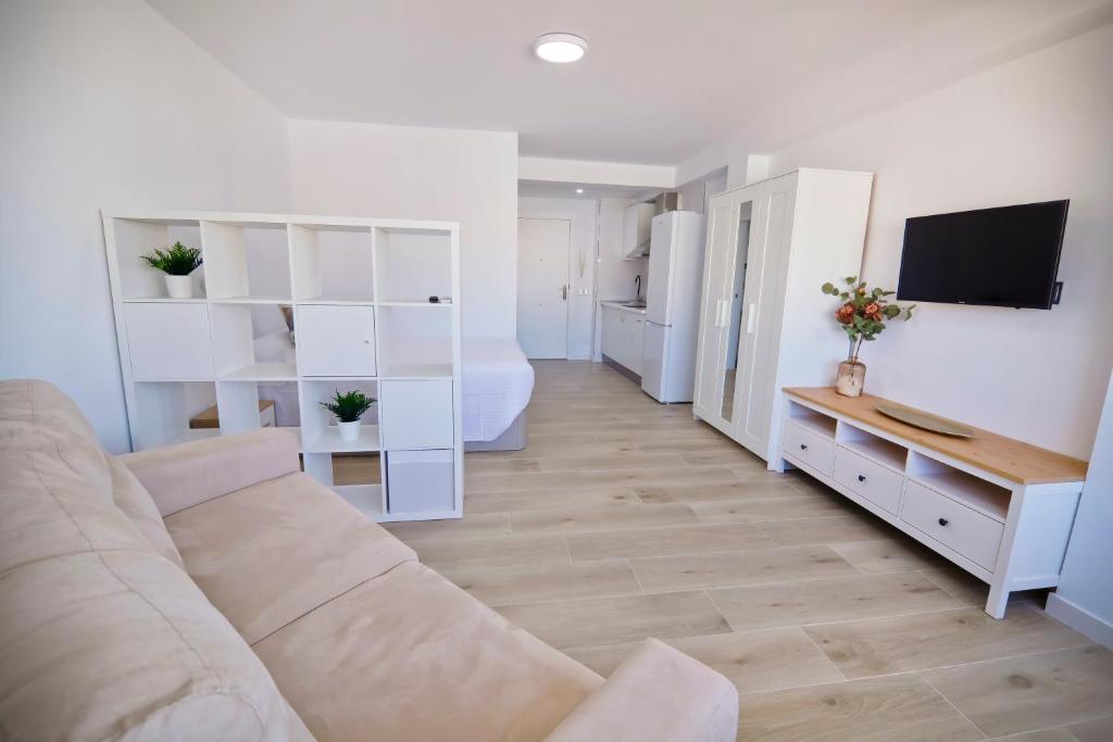 a living room with a couch and a bedroom at Plazamar 6 Jose in Torre del Mar