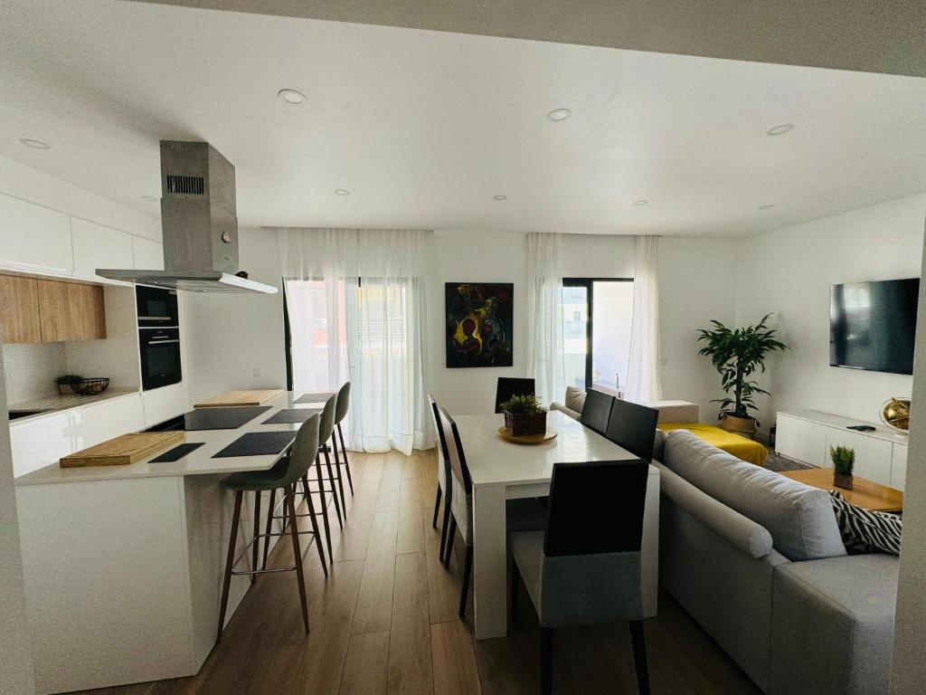 a kitchen and living room with a couch and a table at Portimão holiday home by Kerum in Portimão