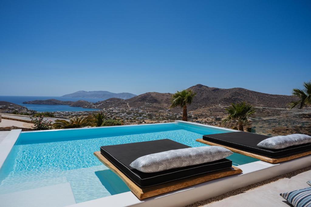 two massage mattresses sitting on top of a swimming pool at Youtopia Ios Villas in Ios Chora