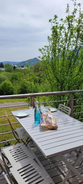 - une table de pique-nique sur une terrasse avec vue sur les montagnes dans l'établissement Maison au calme, proche Chambéry, à Vimines