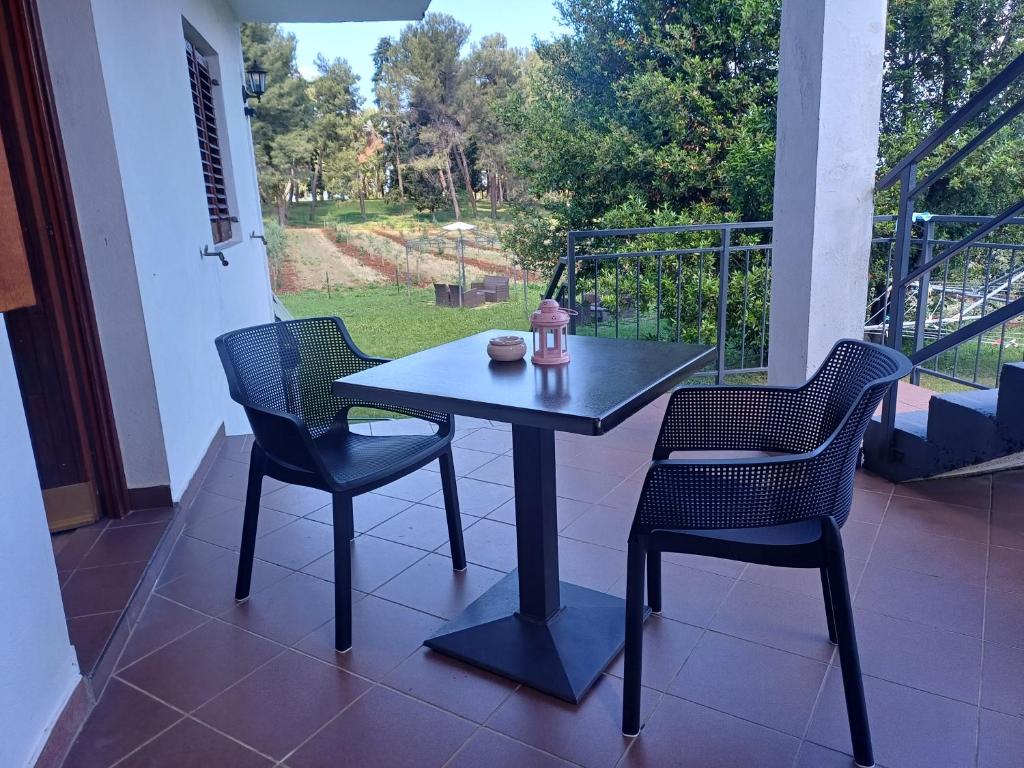 a black table and chairs on a porch with a view at Apartments & Rooms Darrer in Poreč