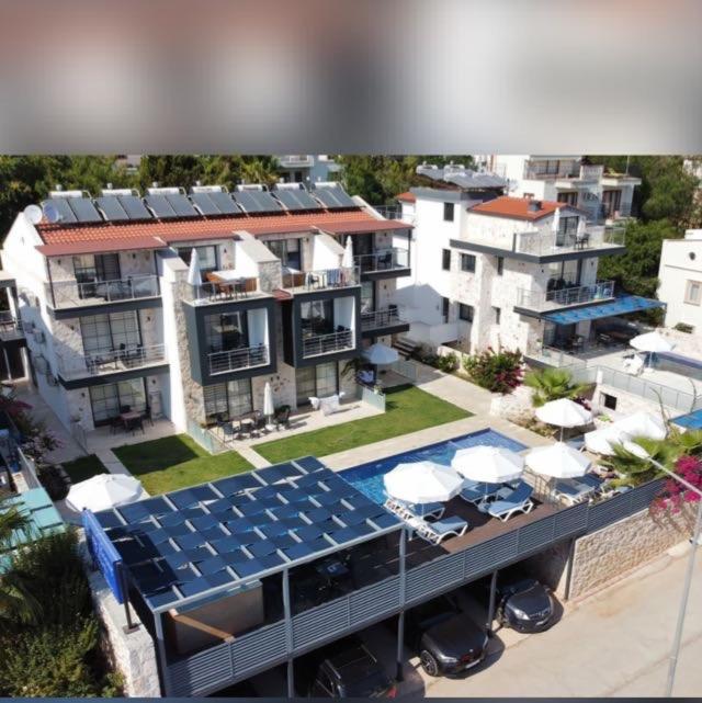an aerial view of a building with a swimming pool at Stone House Aparts 2 plus 1 mit Poolterrasse Kalkan No 2 in Kalkan