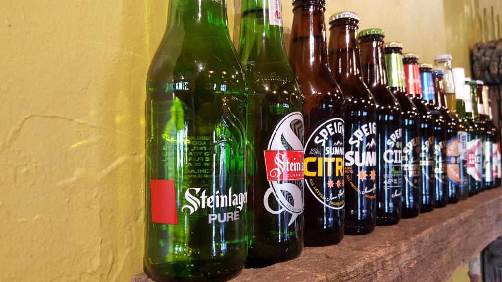a row of beer bottles lined up on a wall at Ski Time in Methven