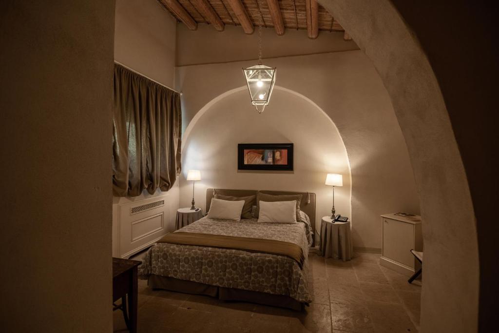 Postel nebo postele na pokoji v ubytování Castello Camemi