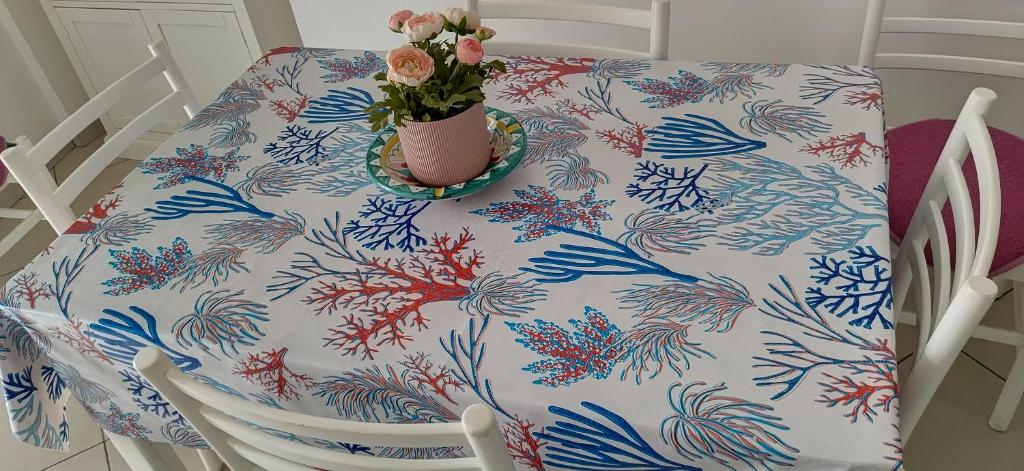 a chair with a flower pot on top of it at Casadduoglio home costa d'Amalfi in Vietri sul Mare