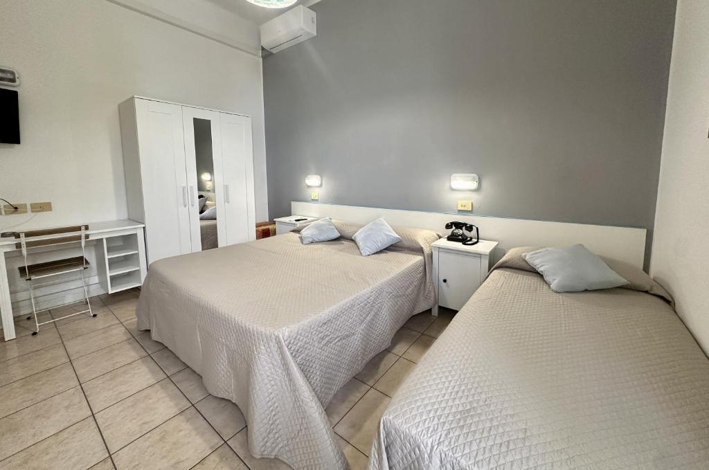 Postel nebo postele na pokoji v ubytování Hotel Amelia