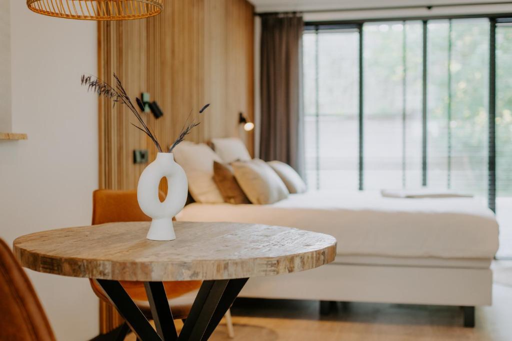 a living room with a bed and a table with a table sidx sidx at Bed & Breakfast BBNo9 in Arum