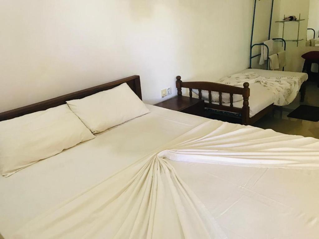 Postel nebo postele na pokoji v ubytování Gimansa Rest Sigiriya