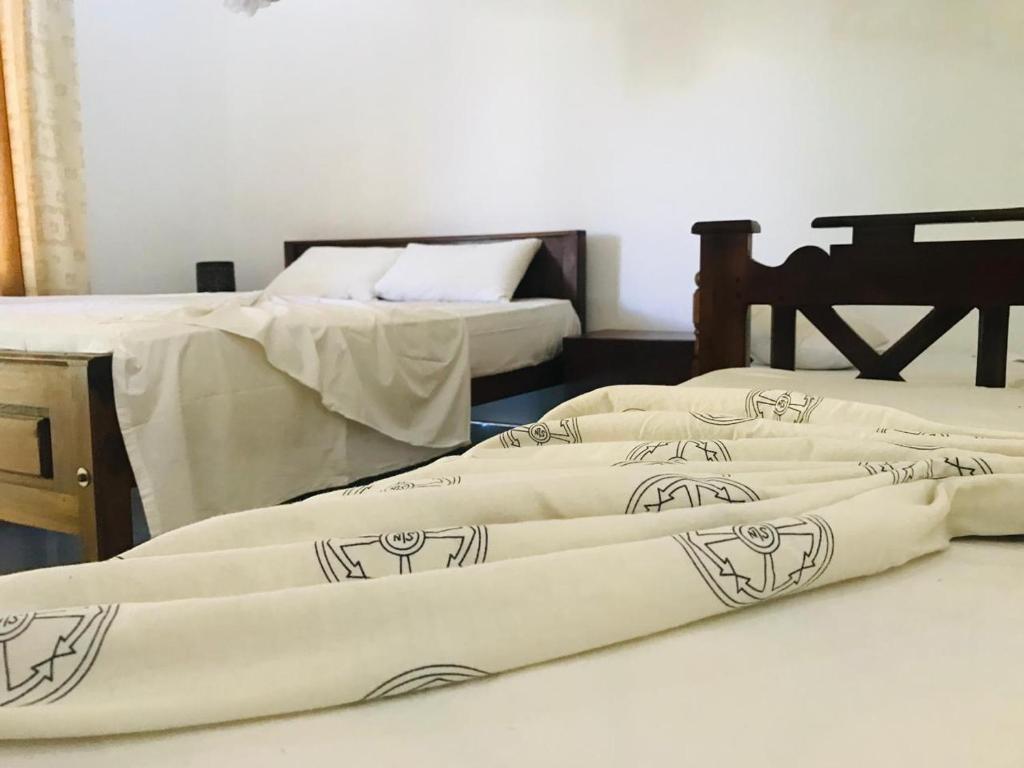 Postel nebo postele na pokoji v ubytování Gimansa Rest Sigiriya
