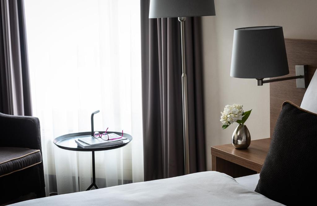 Postel nebo postele na pokoji v ubytování AMERON Luzern Hotel Flora