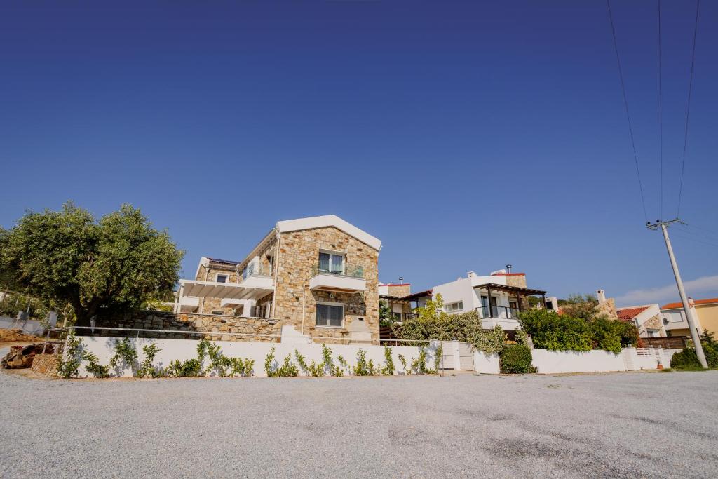a large stone house in the middle of a street at Petritis Villas in Iraklitsa