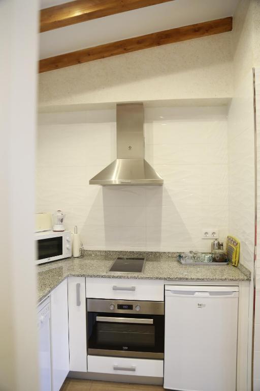 A kitchen or kitchenette at Apartamentos La Arena