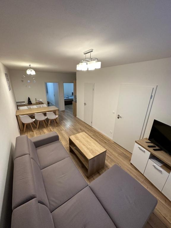 a living room with a couch and a table at Apartmán B3 Biela Púť - Jasná in Demanovska Dolina