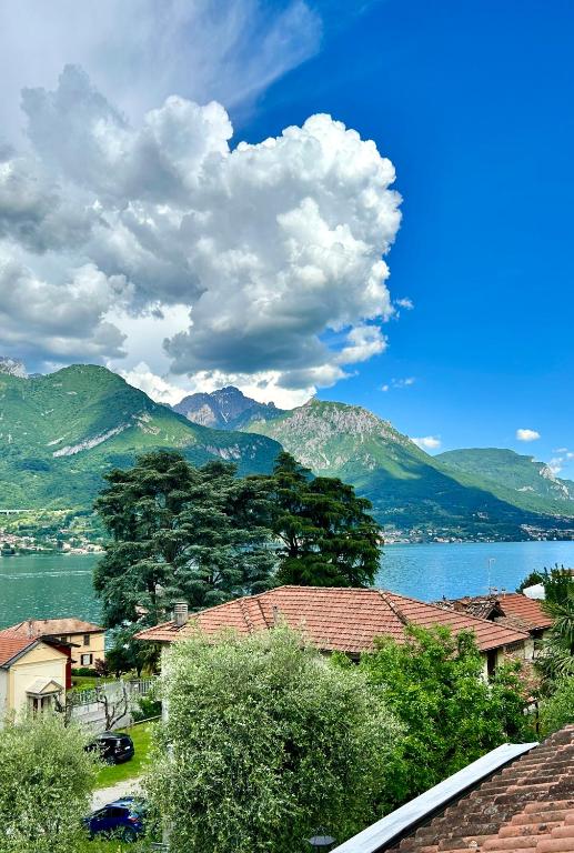 a view of a large body of water with mountains at Bellagio Neighbor Apartment in Limonta