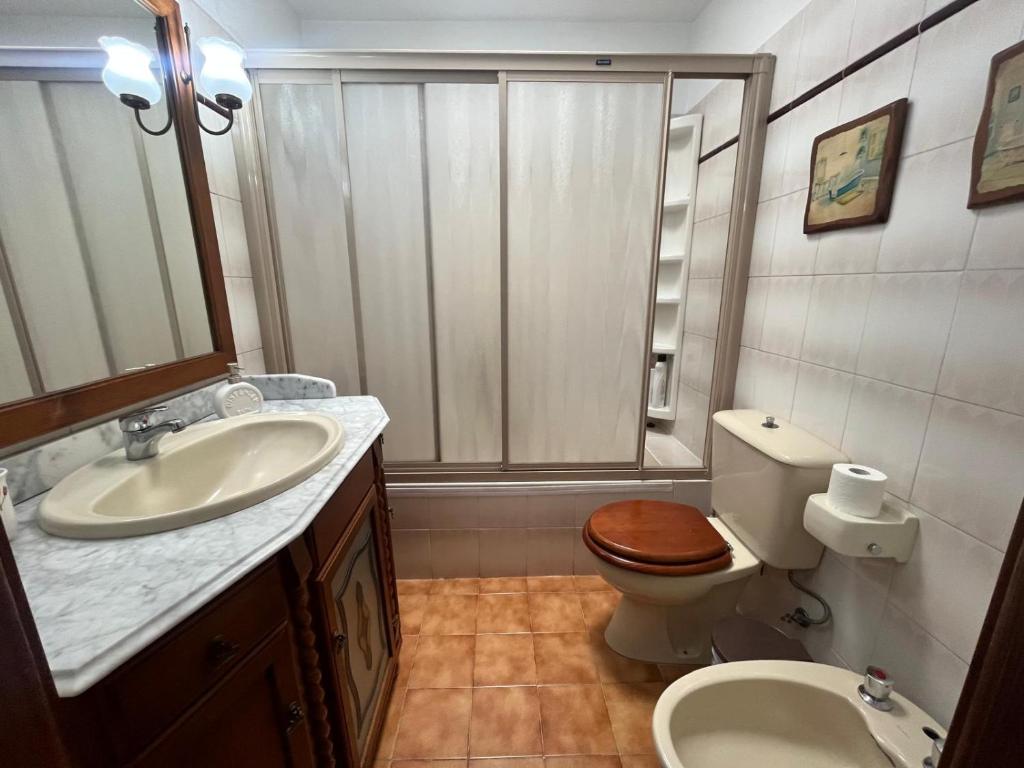 a bathroom with a sink and a toilet and a shower at Saltflat2, be surrounded by sun, water and peace in Los Cancajos
