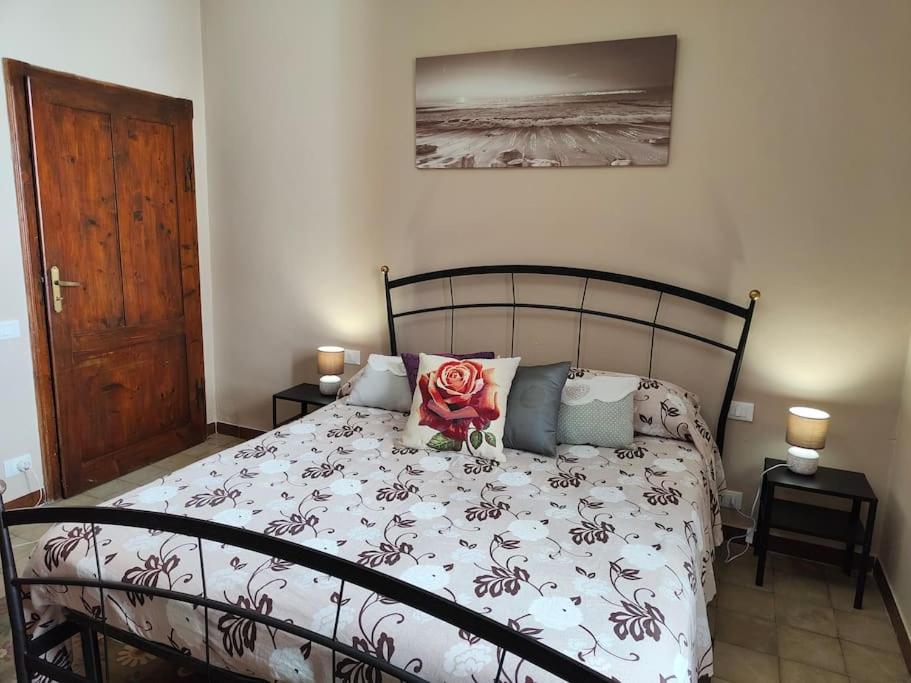 Un dormitorio con una cama con una flor. en La Casa di Alex - Alex's House, en Colle Val D'Elsa