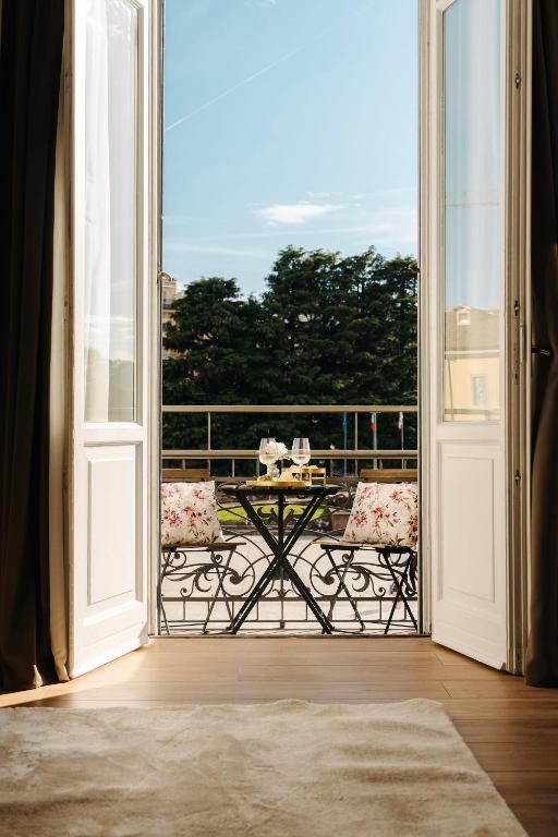 an open door to a balcony with a table at La Suite del Centro in Varese