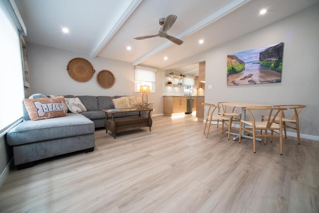 a living room with a couch and a table at La Jolla Windansea Luxury Apt in San Diego