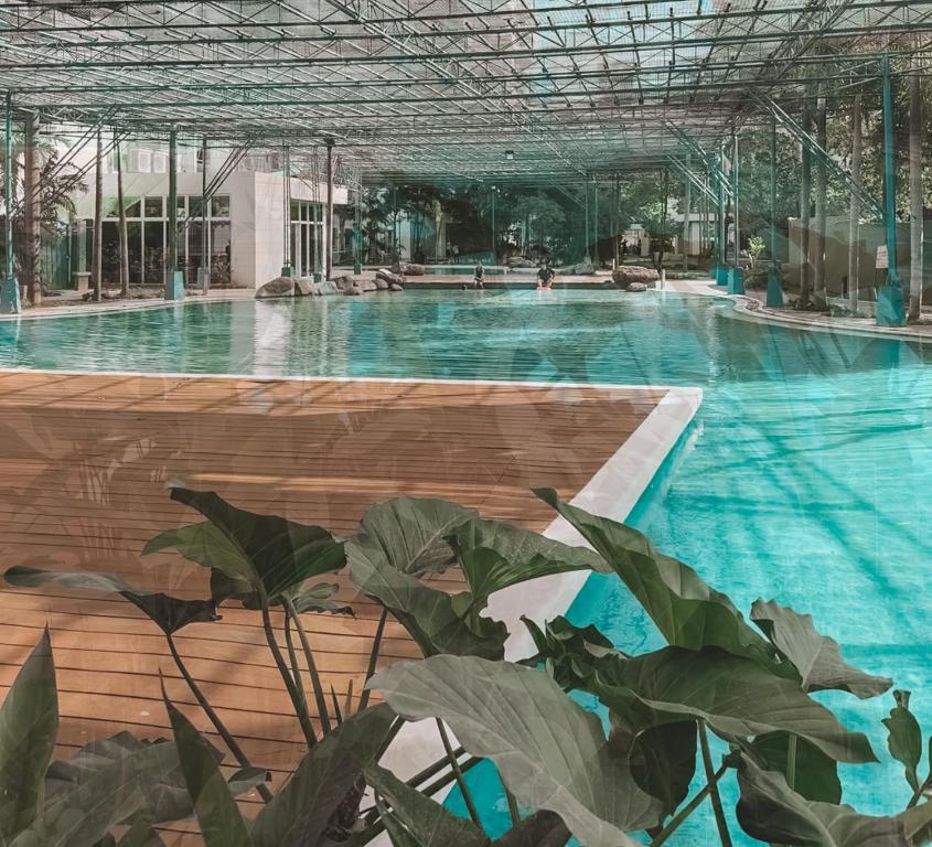 a swimming pool with blue water in a building at Mayas Home in Pasig Aesthetic and Cozy with Pool access and Netflix in Manila