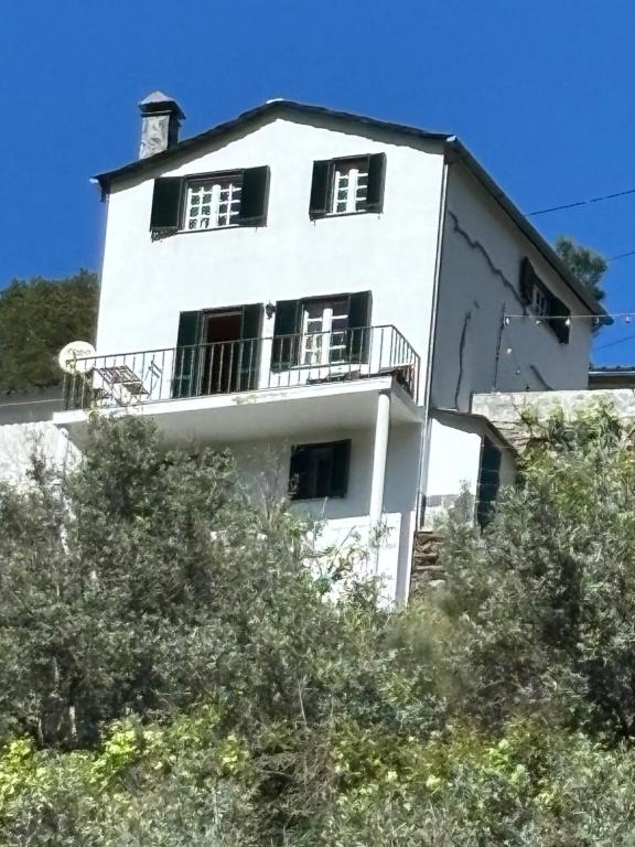 a white building with a balcony on top of it at White House in Piódão