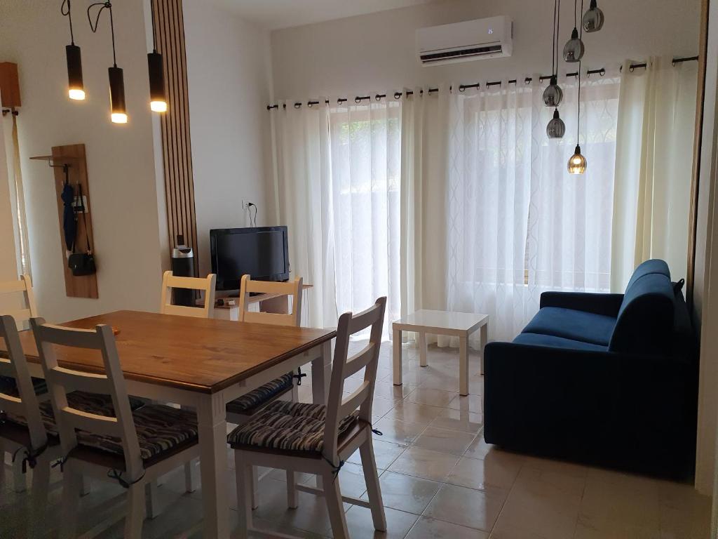 a living room with a table and a blue couch at Casa di Giovanna in Scalea