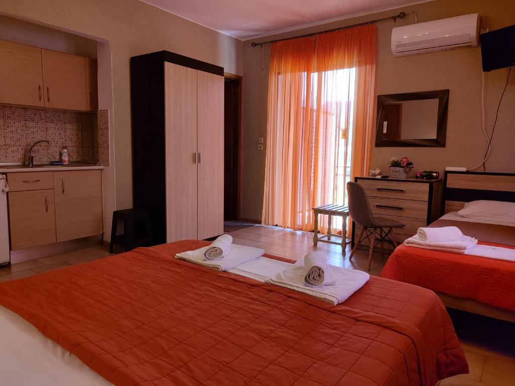 a hotel room with two beds and a kitchen at Villa Anastasia in Limenas