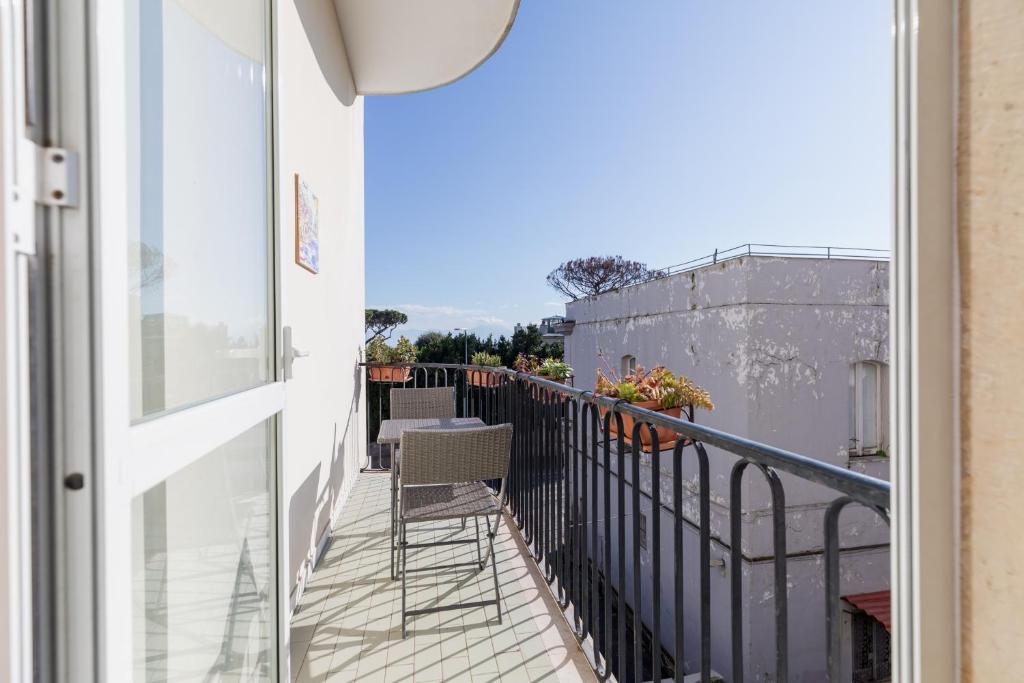 a balcony with a table and a chair on it at una bomboniera a Posillipo in Naples